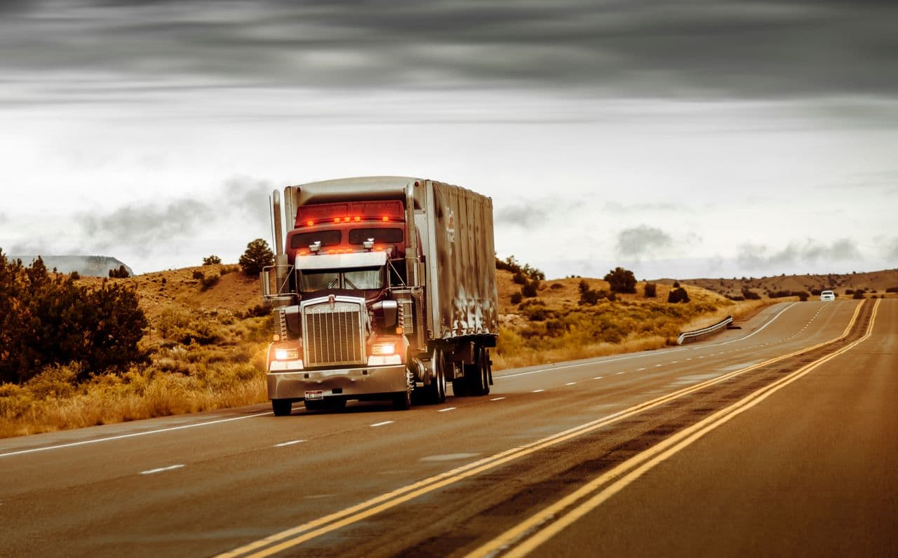 A semi truck on a desert highway
