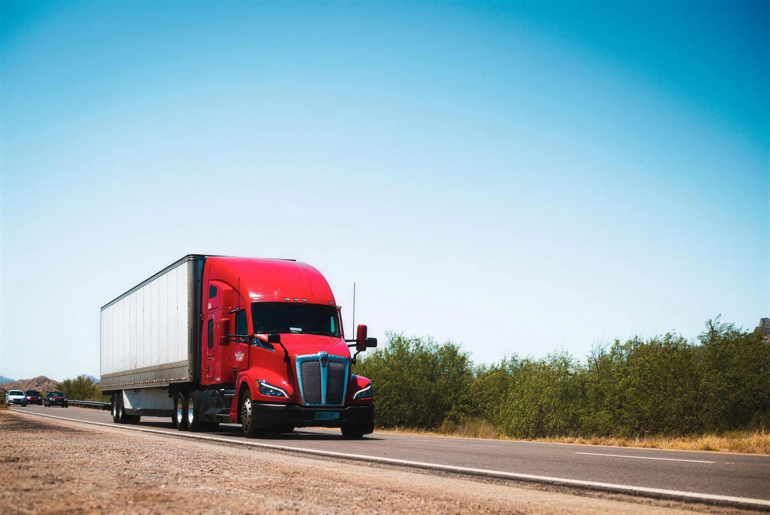 A red semi truck on a highway